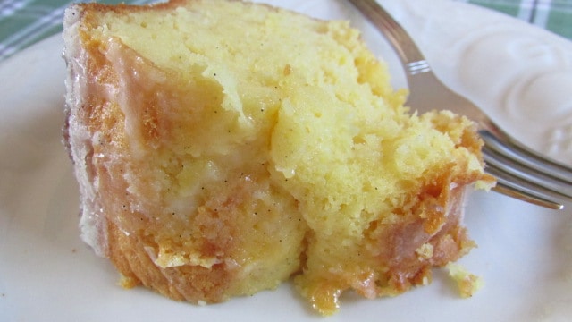 Pineapple Bundt Poke Cake slice of cake and fork on white plate