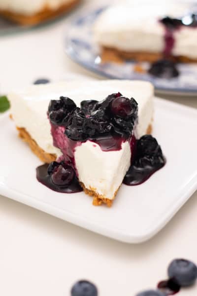 slice of no bake cheesecake with blueberry pie topping