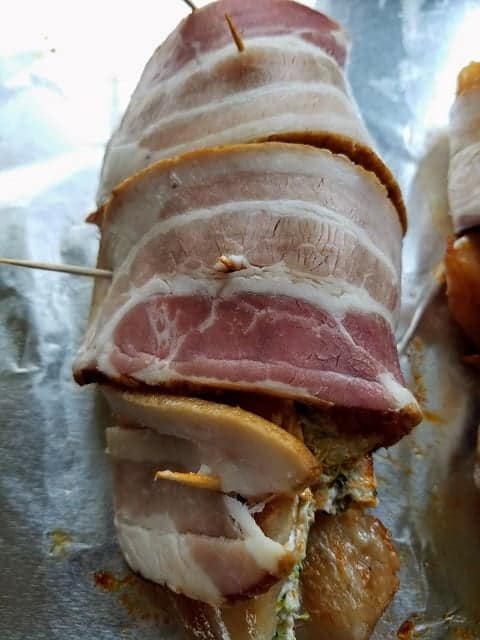 wrap each slice of bacon around stuffed chicken stick toothpicks to hold chicken together