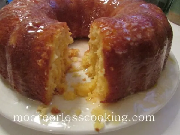 Pineapple Bundt Poke Cake whole cake slice cut out on white plate