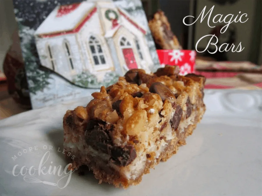 one magic bar in front of Christmas house and container of magic bars