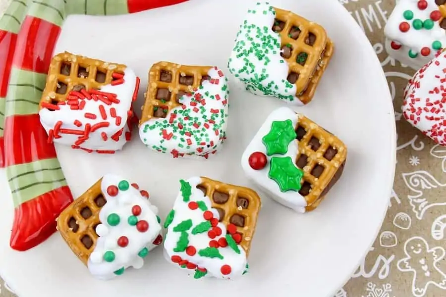 Christmas Chocolate Pretzel Sandwiches are so pretty and delicious to eat! These are super cute and easy to make!! Everyone will love the candy bar surprise in the middle!! Great to place in baggies and give them to your neighbors, co-workers, teachers, friends, and family!! via @Mooreorlesscook