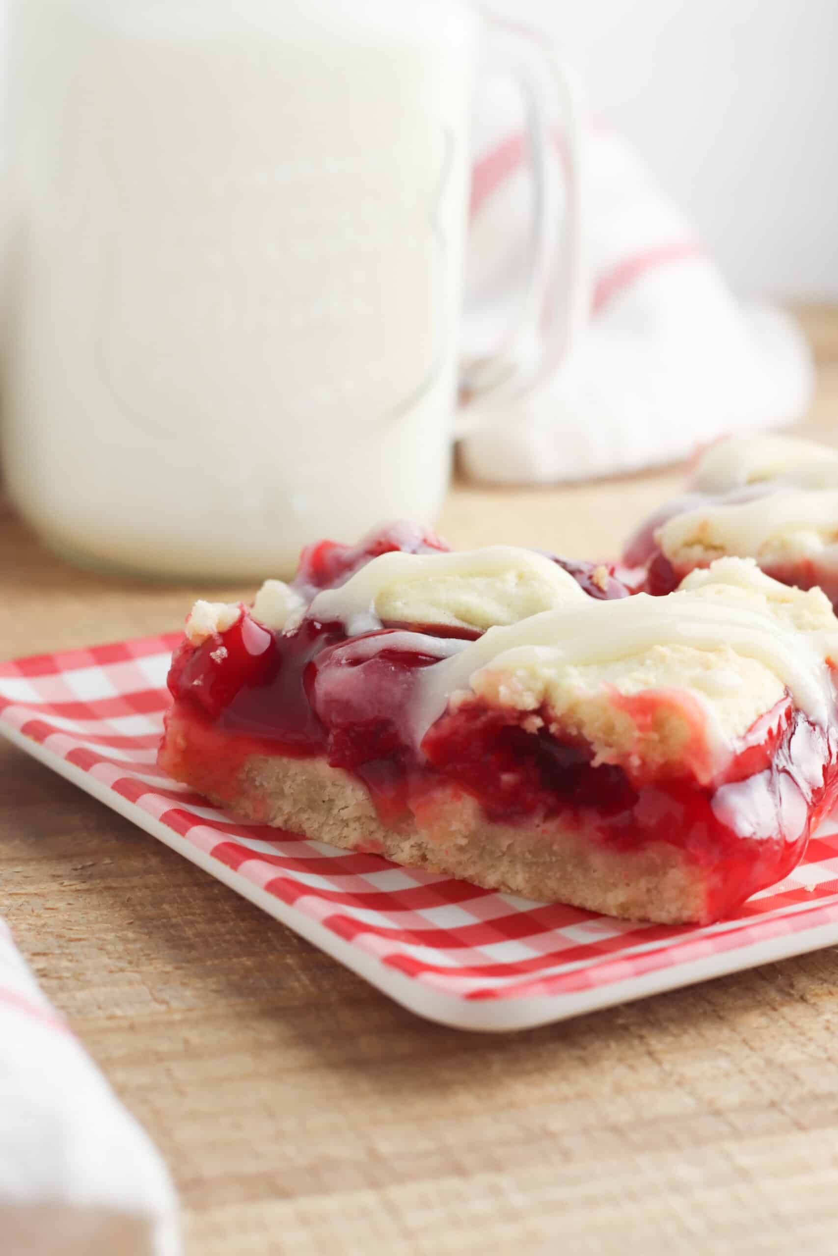 Cherry Pie Bars served on a red checkered plate