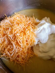 Add sour cream and shredded cheese