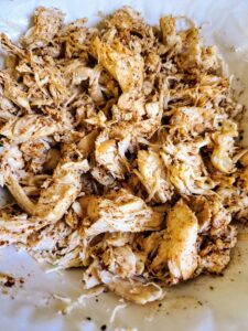 Mix spices with shredded chicken