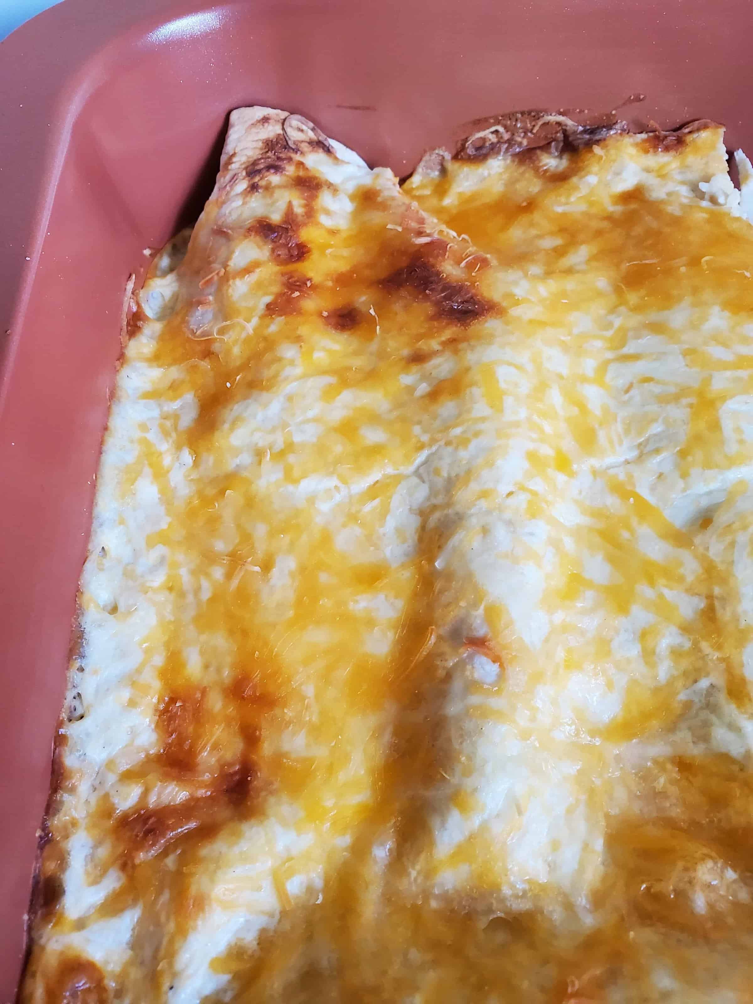 #ad @HpHood Sour Cream Chicken Enchiladas~ Creamy chicken and cheese enchiladas with a flavorful sour cream white sauce is a simple and delicious meal that comes together quickly. #TouchOfHood #IC #mooreorlesscooking #enchiladas #sourcream via @Mooreorlesscook