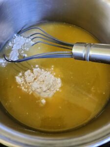 Whisk flour and chicken broth