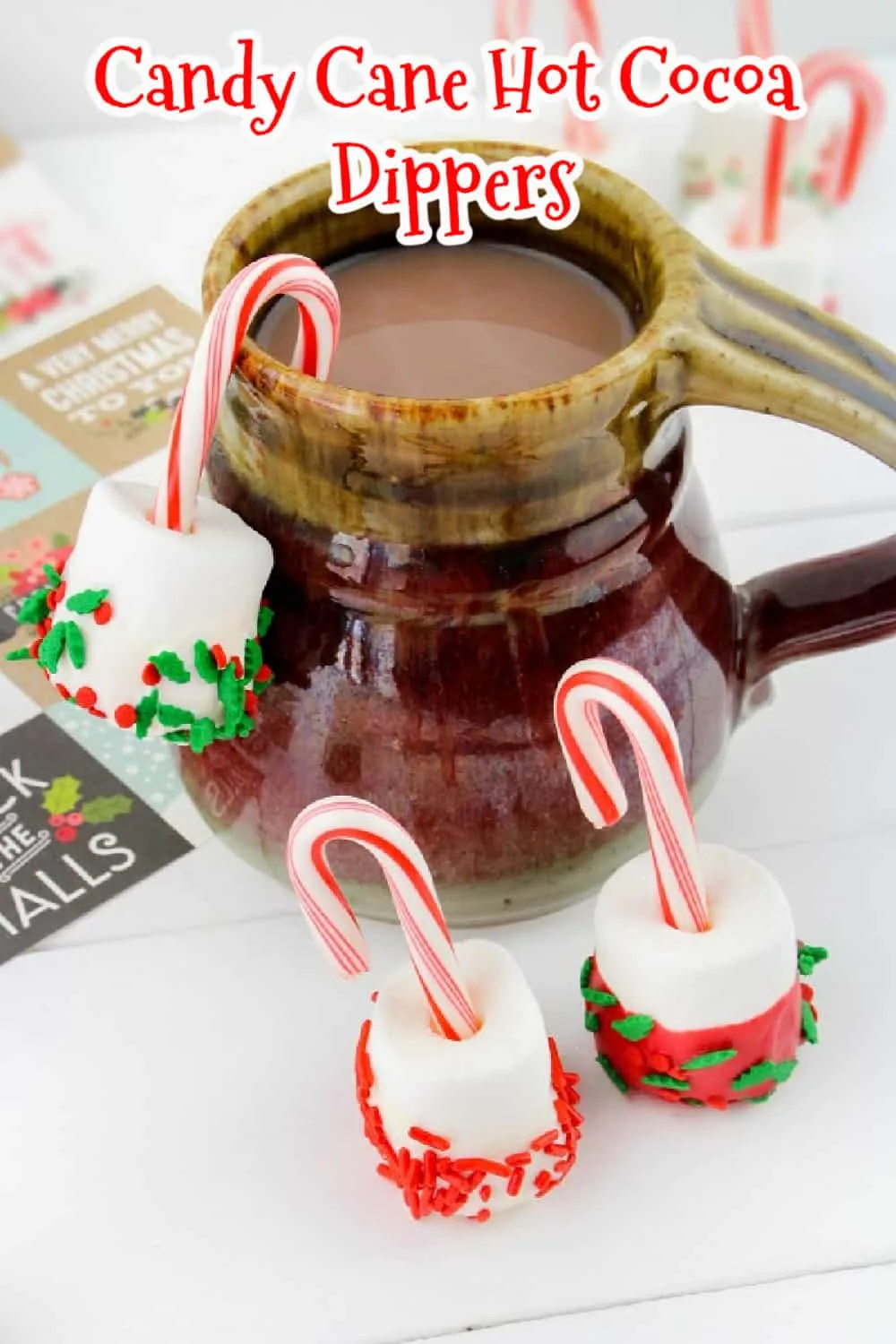 These jolly Candy Cane Hot Cocoa Dippers are a festive way to add marshmallows to hot chocolate. They’re a fun way to melt a sweet and creamy marshmallow and to add a touch of peppermint to your hot cocoa. via @Mooreorlesscook