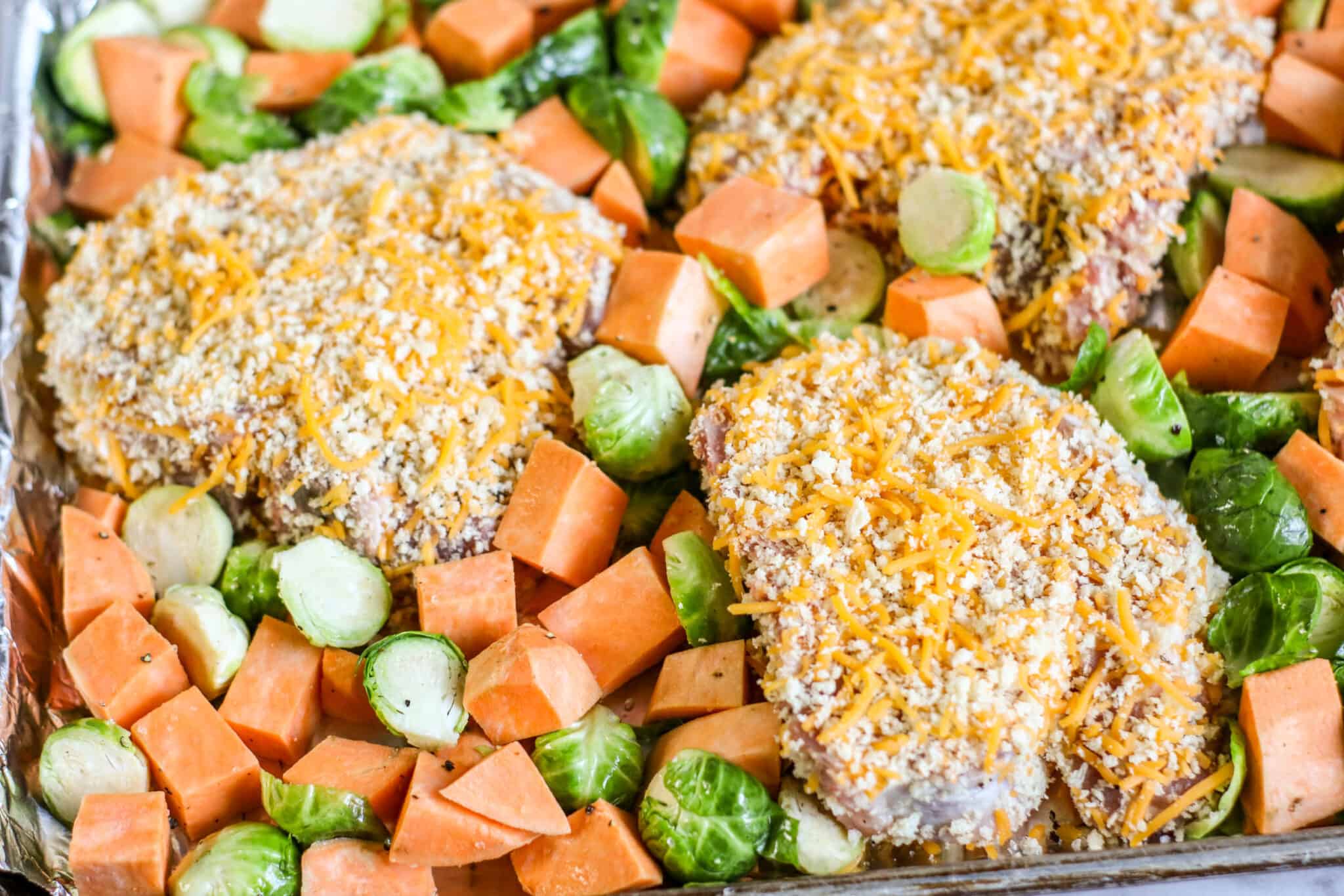 Sheet Pan Crispy Cheddar Pork Chops with Brussels Sprouts and Sweet