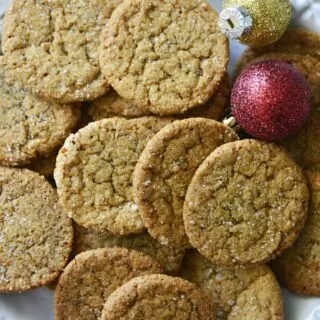 crispy delicious gingersnap cookies on plate with Christmas ball