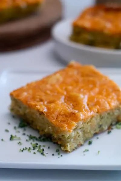 sliced broccoli cheddar cornbread on white plate 