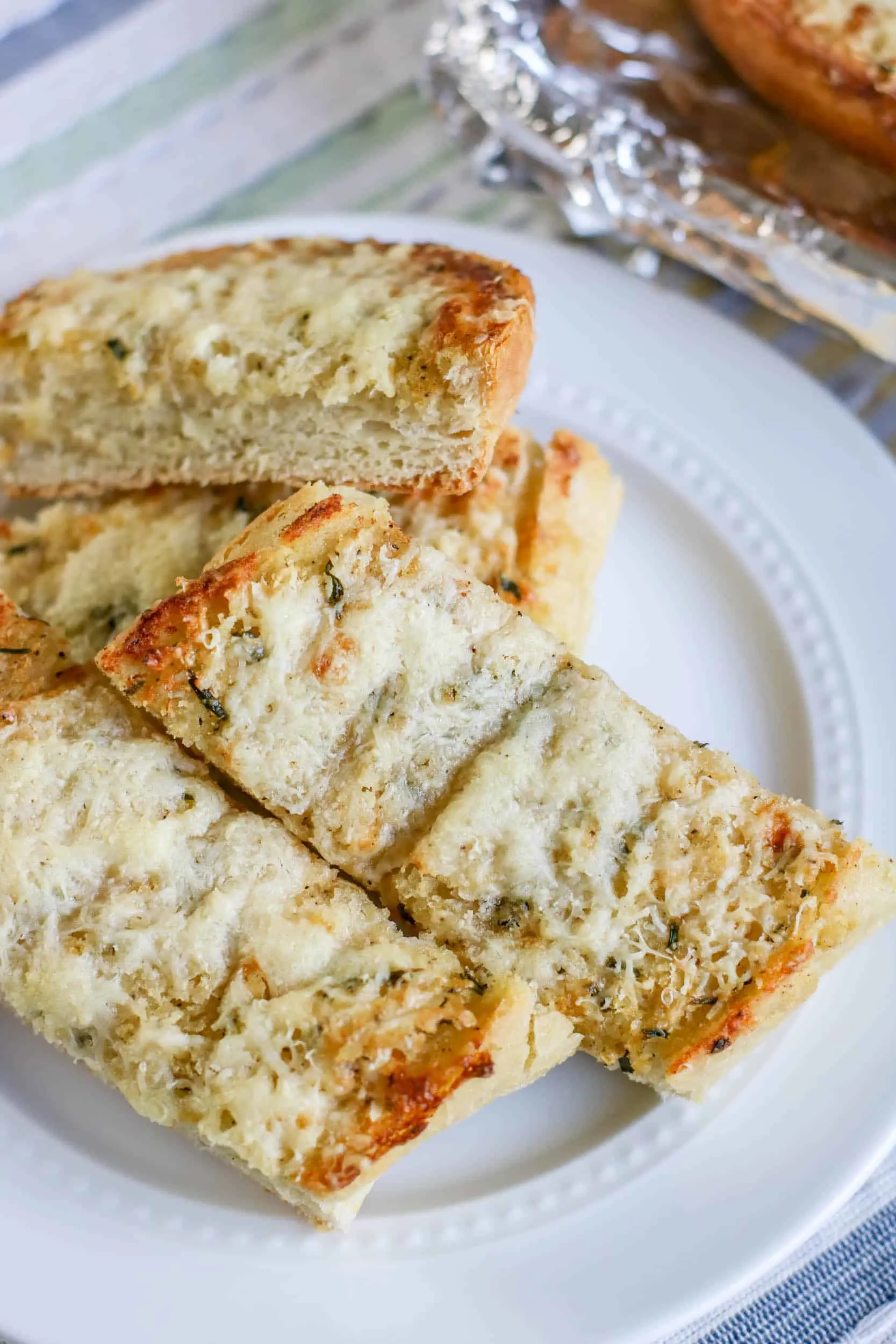 Slathered with a homemade herbed garlic butter spread and garnished with two kinds of cheese, French bread gets toasted to savory perfection with this irresistible cheesy garlic bread recipe. via @Mooreorlesscook