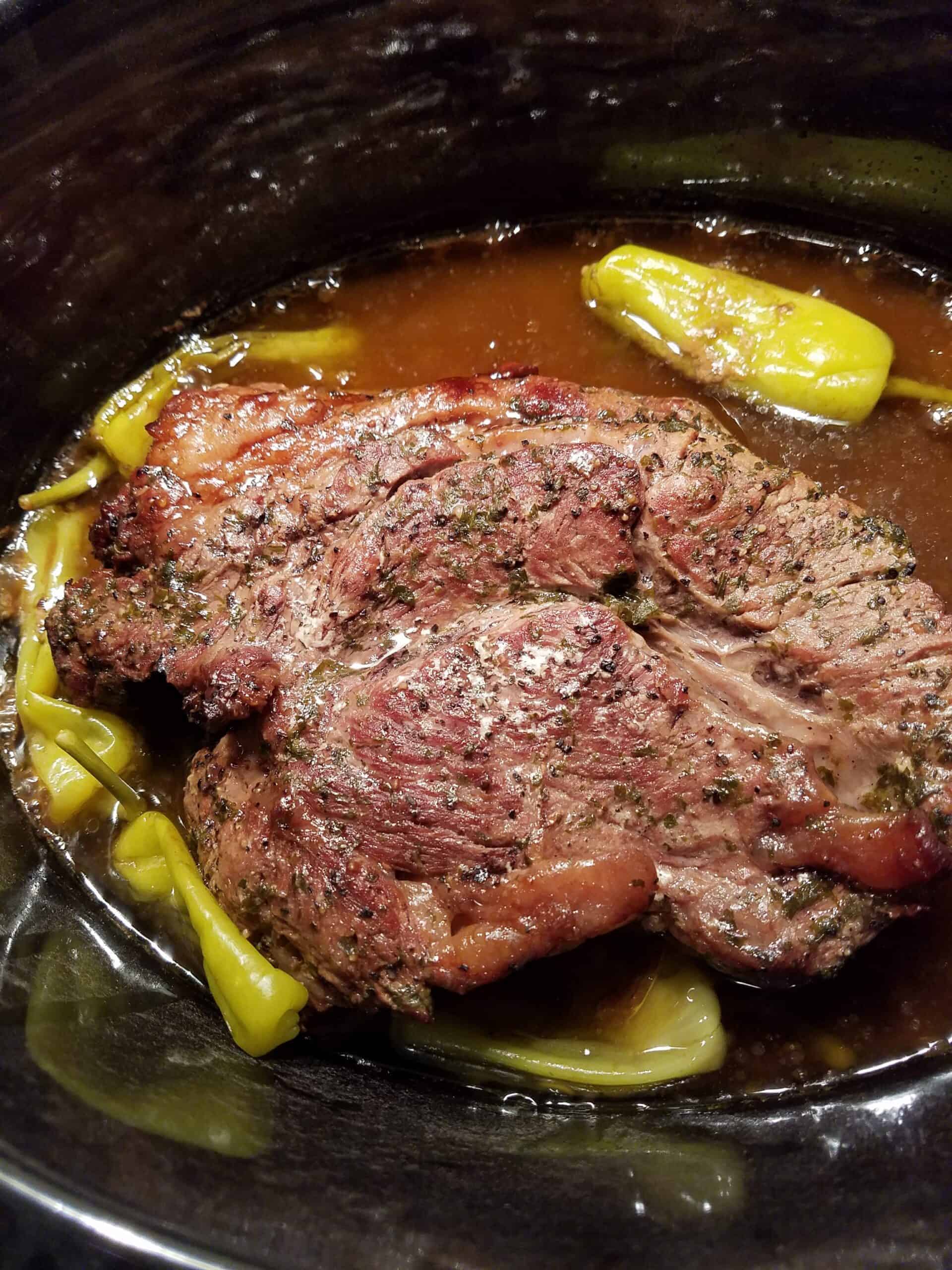 finished cooked beef roast and peppers in crockpot