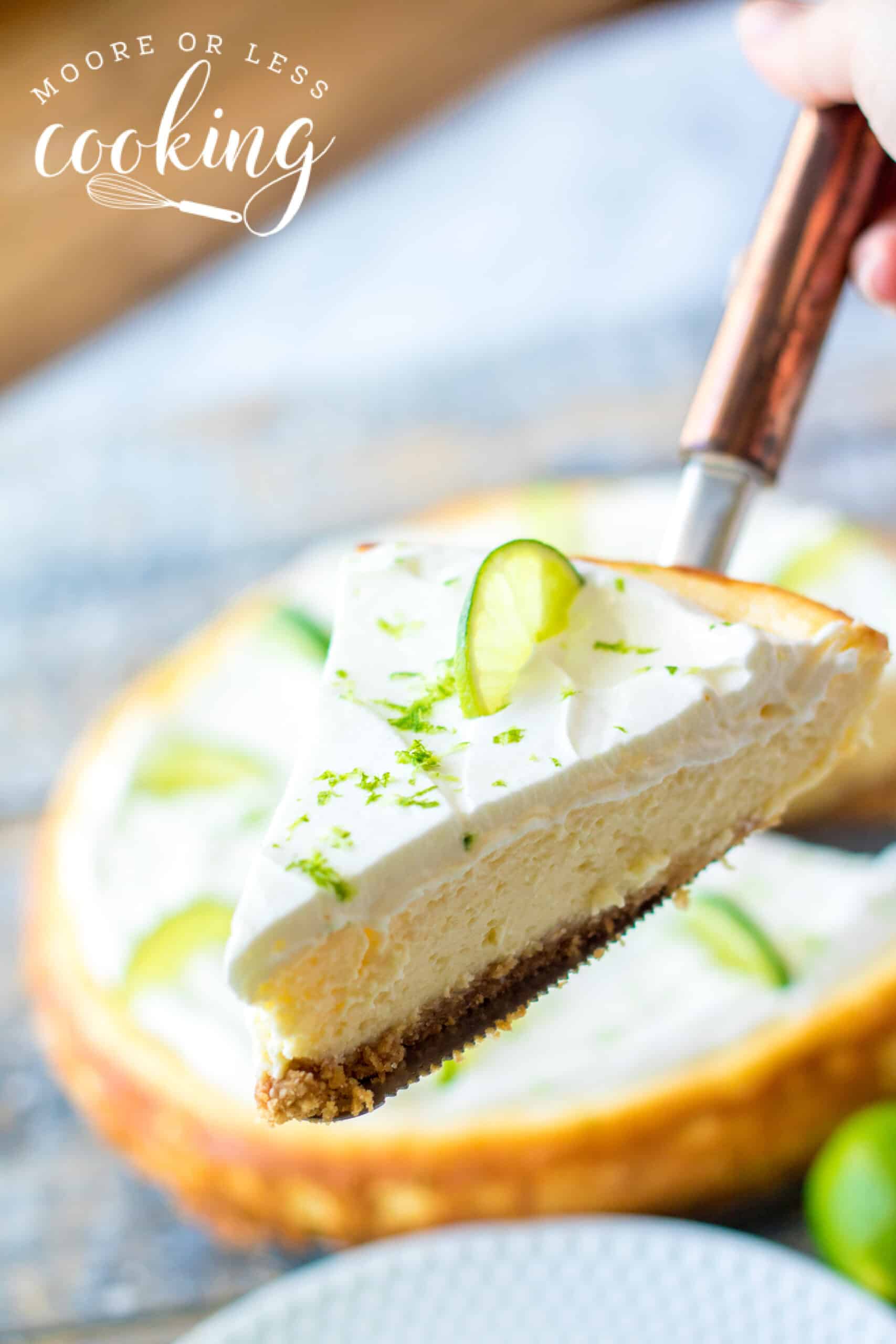 slice held to camera of Cheesecake Factory Copycat Key Lime Cheesecake