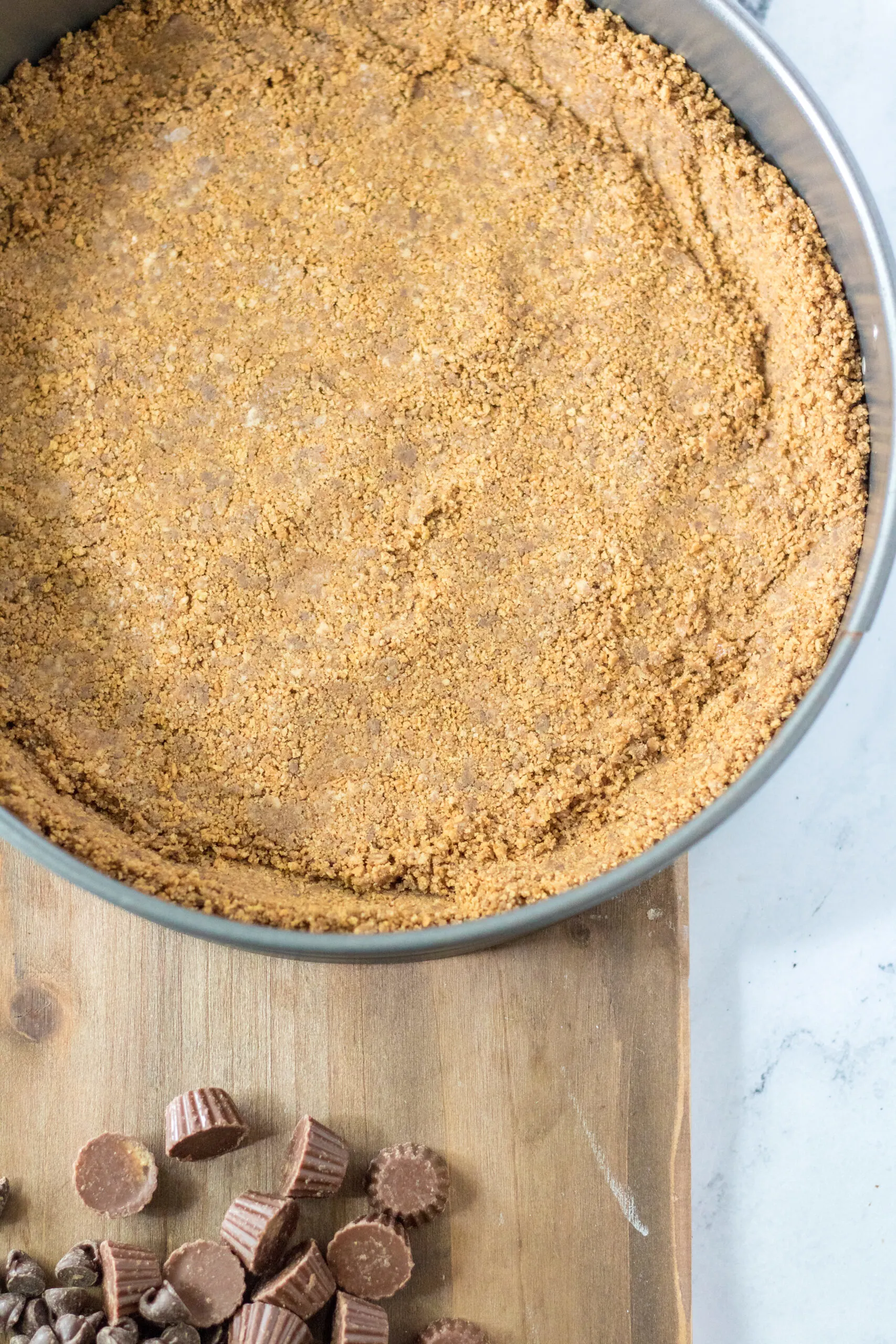 crust for the peanut butter cup cheesecake before pouring filling in