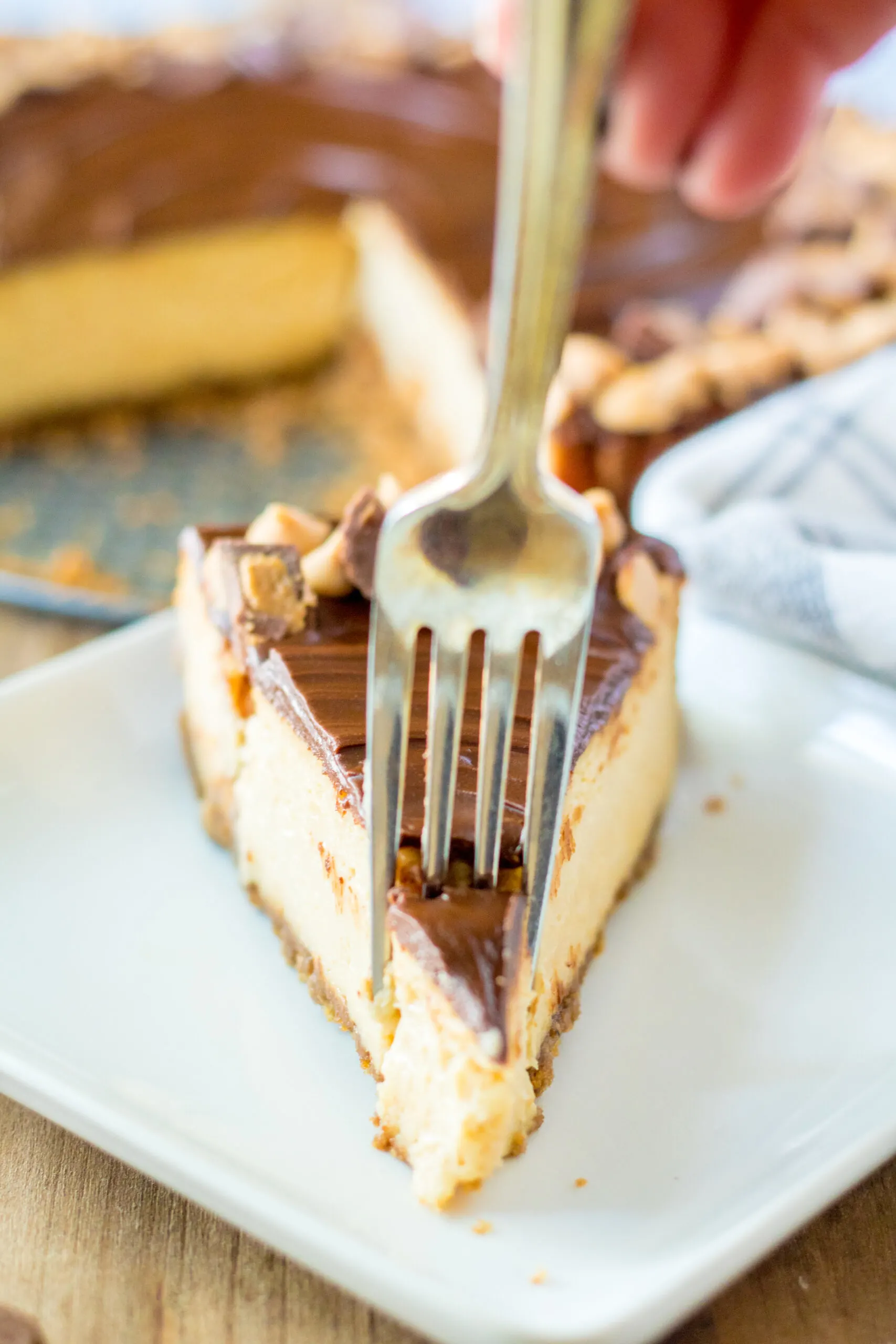 slice of peanut butter cup cheesecake with a silver fork