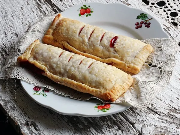 2 mcdonalds cherry pies on floral plate on wood table