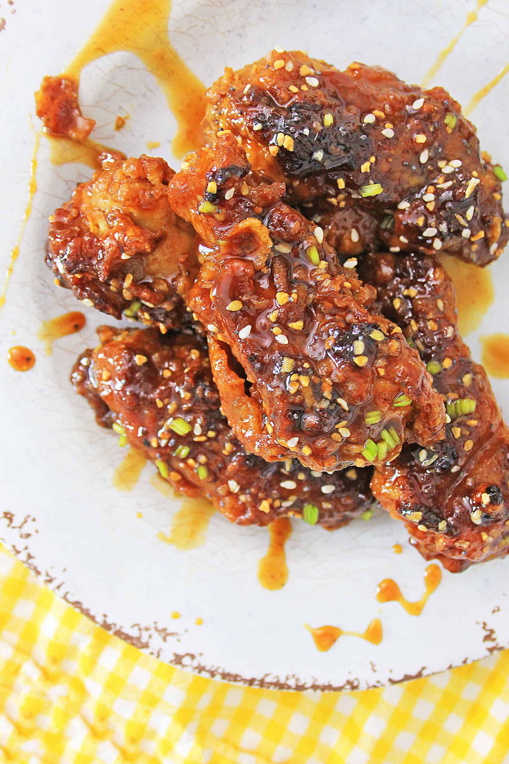 Air Fryer Korean BBQ Chicken Wings on a plate with drizzled sauce