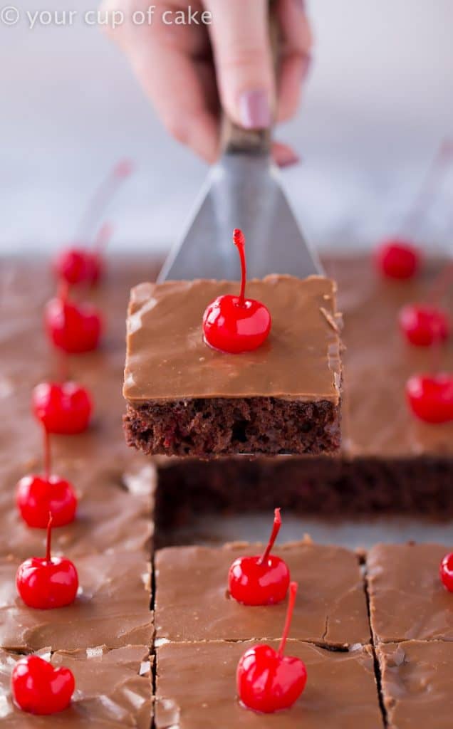 slice of chocolate sheet cake with cherry on top