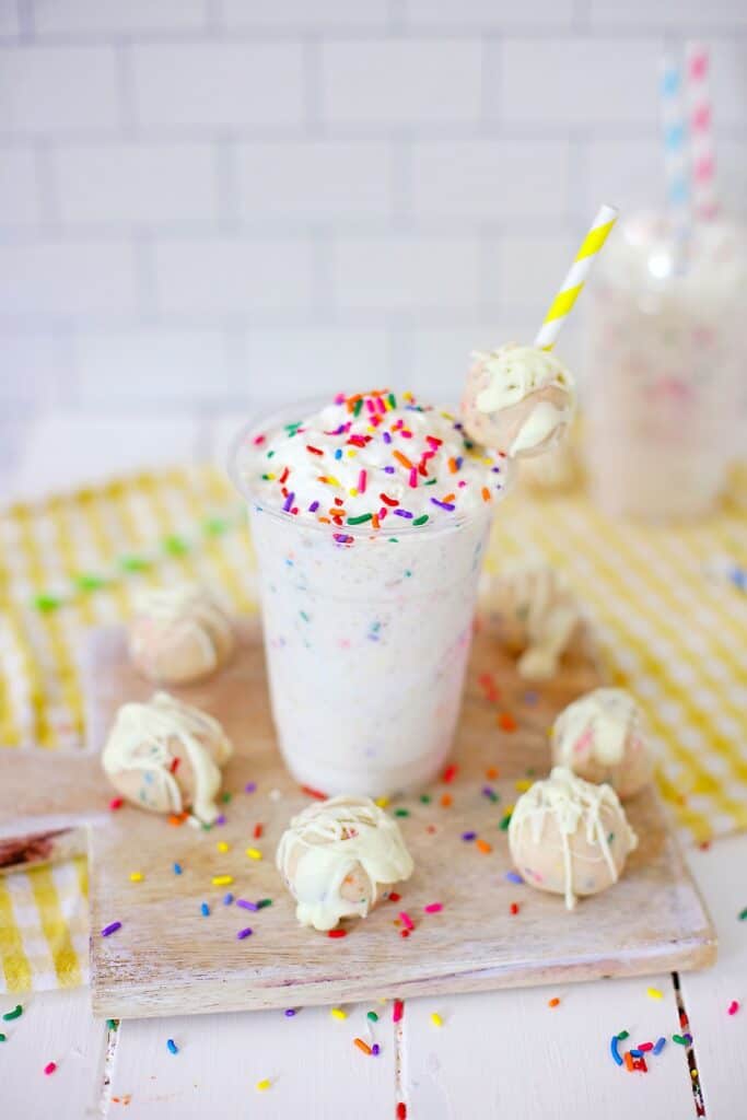 Copycat Starbucks Birthday Cake Frappuccino topped with sprinkles surrounded by a circle of more cake balls
