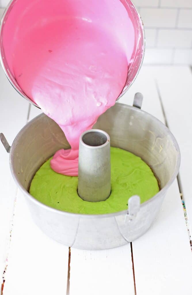 Add the Eggs, Vanilla, and Strawberry Flavoring, and blend until all ingredients are well mixed.  
Scrape down the sides of the mixing bowl, and mix until the ingredients are well mixed.  
Add the Food Coloring Gel a few drops at a time, and mix well, until desired bright pink color is achieved.  Scrape down the sides of the mixing bowl, again, and blend until smooth, and bright pink. 
