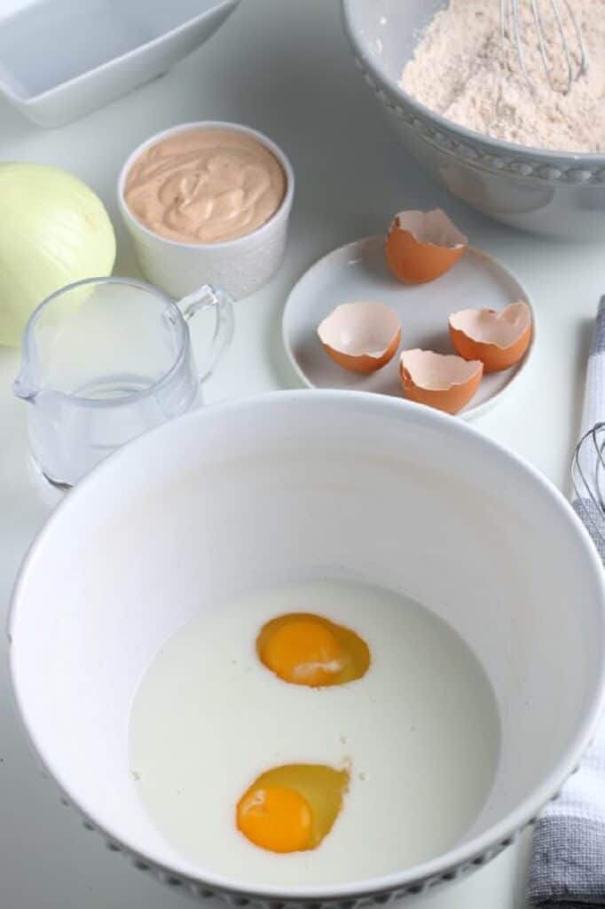 mix up egg and milk with a whisk in a white bowl