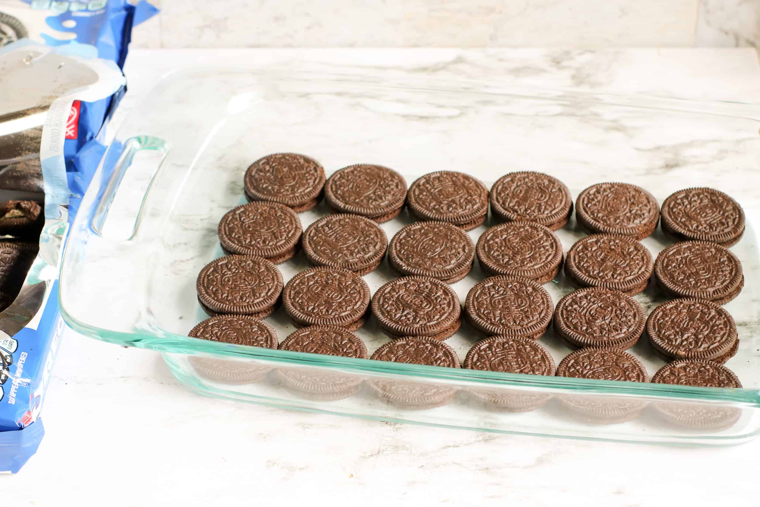lay down one layer of Oreo Cookies in a pyrex glass dish