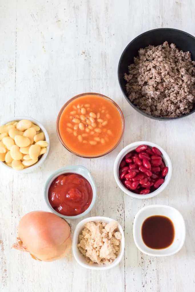 all the ingredients set in separate bowls ready to be poured into the slow cooker