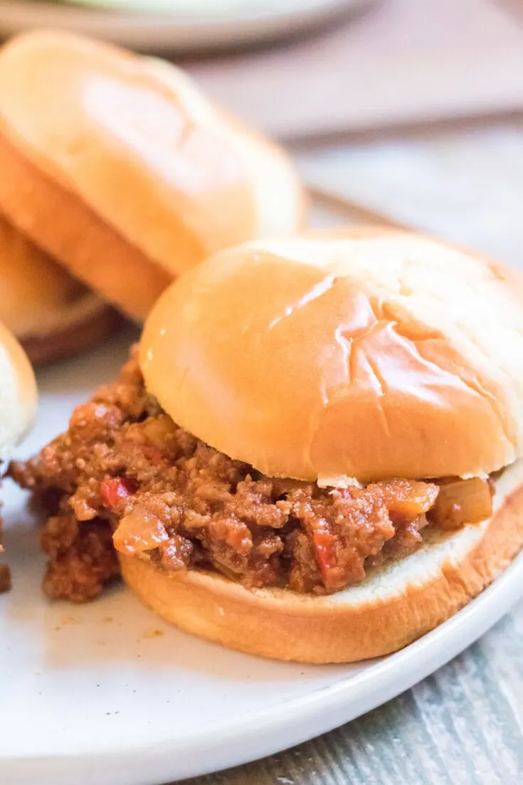 Slow Cooker Sloppy Joes cooked and served on buns served with potato chips