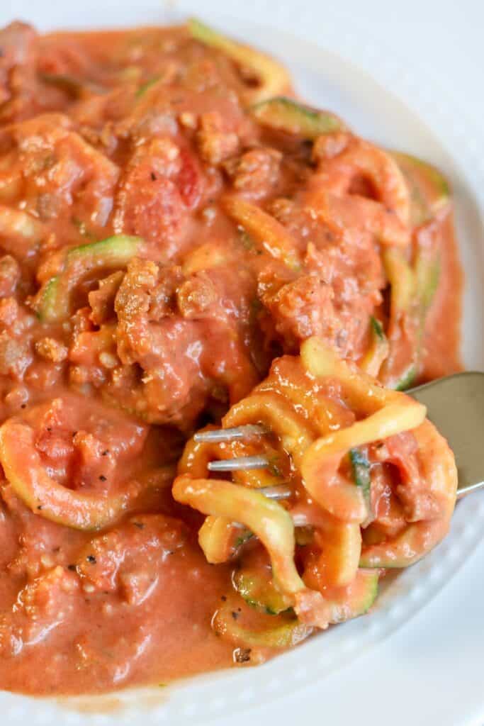 creamy tomato sauce with sausage over zoodles
