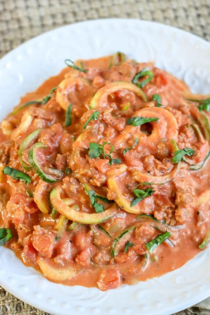 spicy sausage and creamy tomato sauce over zoodles
