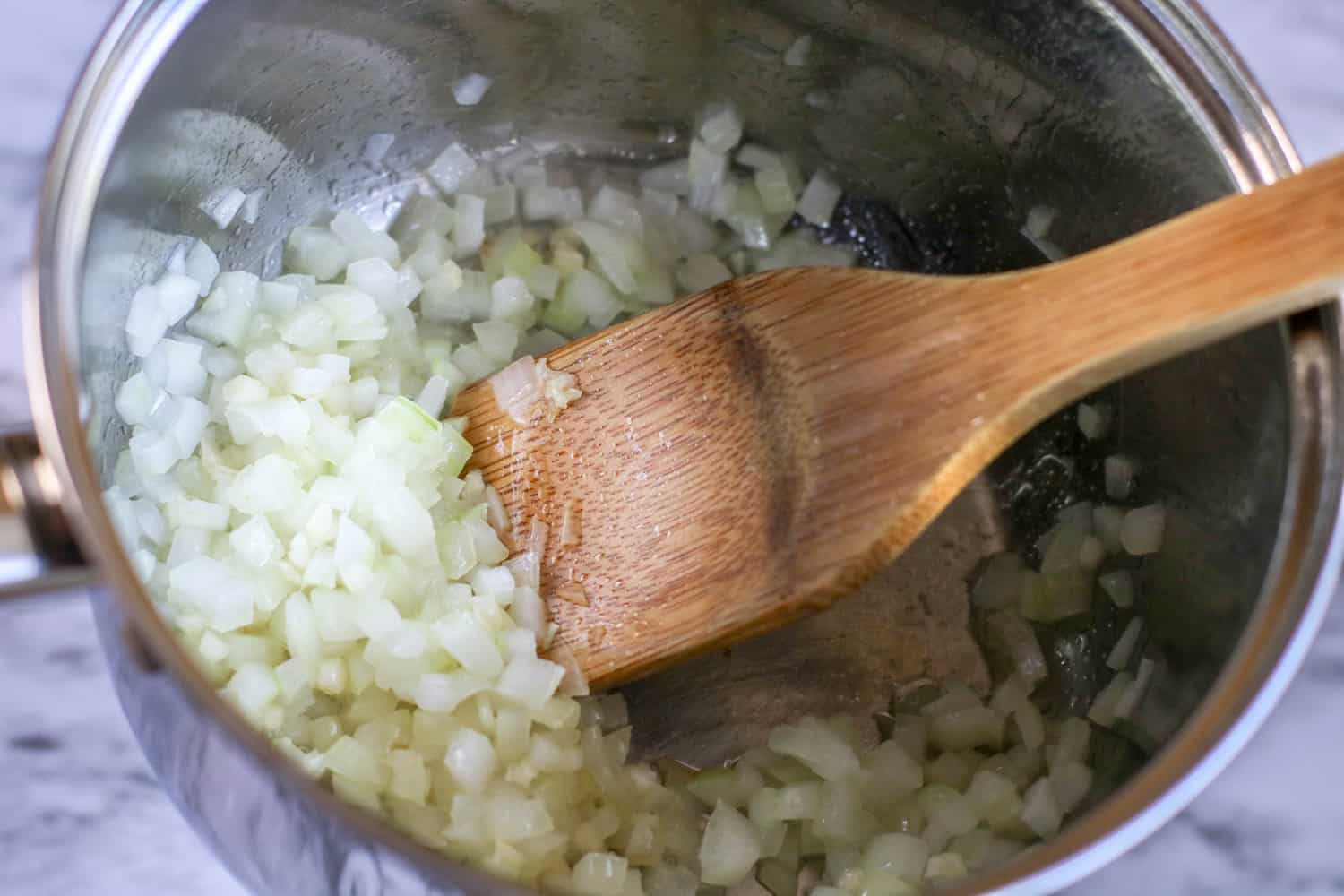 saute chopped onions in a stainless steel pot