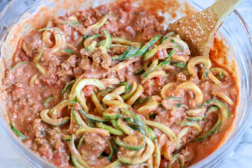 In a large bowl, add zoodles and sauce, using a wooden spoon cover zoodles with sauce