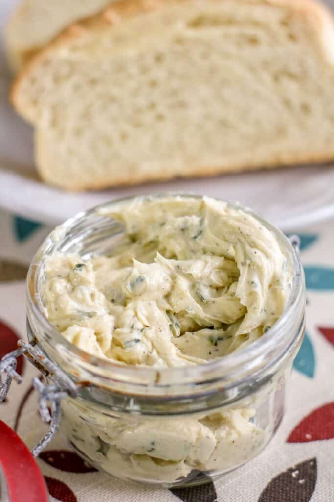 roasted garlic butter hero image in a jar with sliced bread