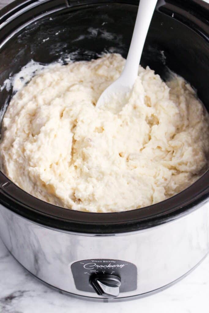 slow cooker mashed potatoes ready to serve in a crock pot