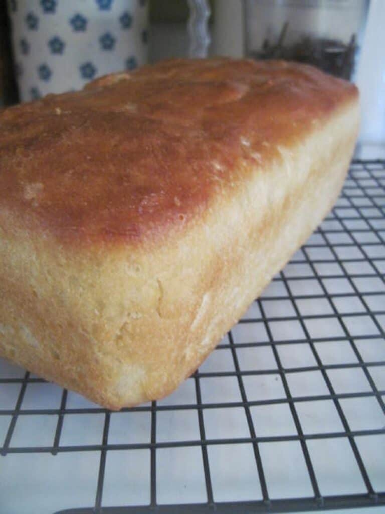 The best English Muffin Bread hero shot perfectly golden brown on a cooling rack