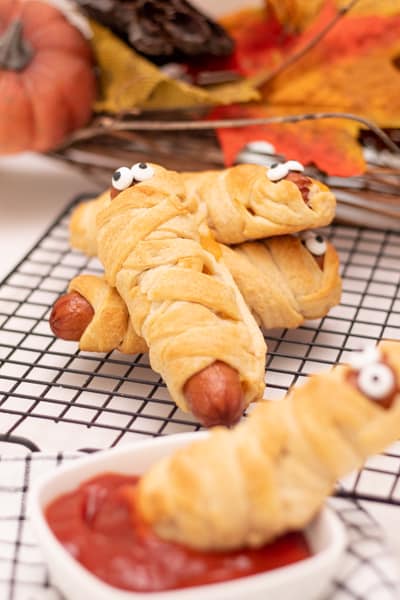 Mummy hot dogs baked on cooling rack