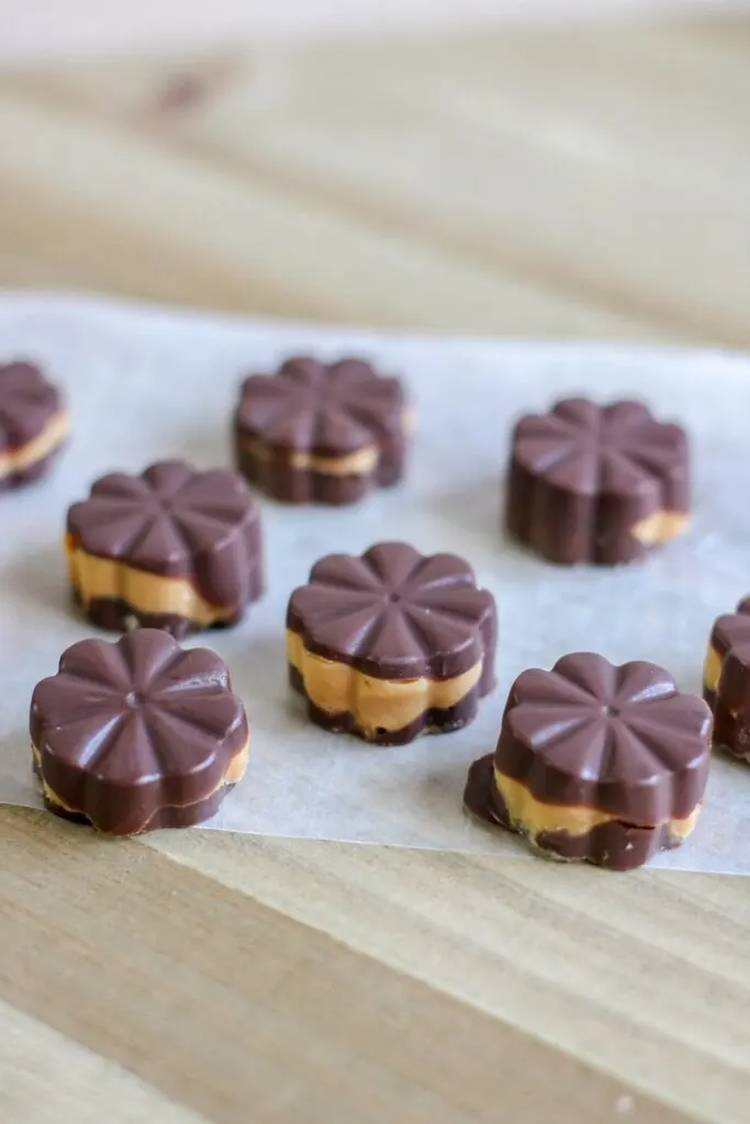 Vertical Keto Peanut Butter Chocolate Fat Bombs Pin on parchment paper