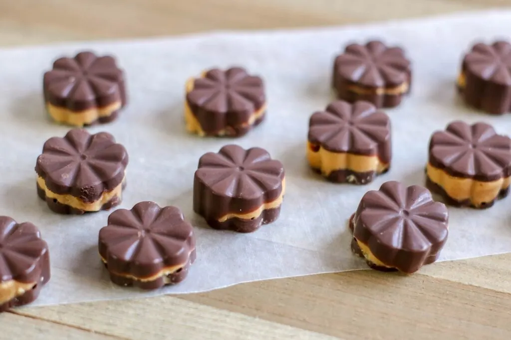 Horizontal Keto Peanut Butter Chocolate Fat Bombs on parchment paper
