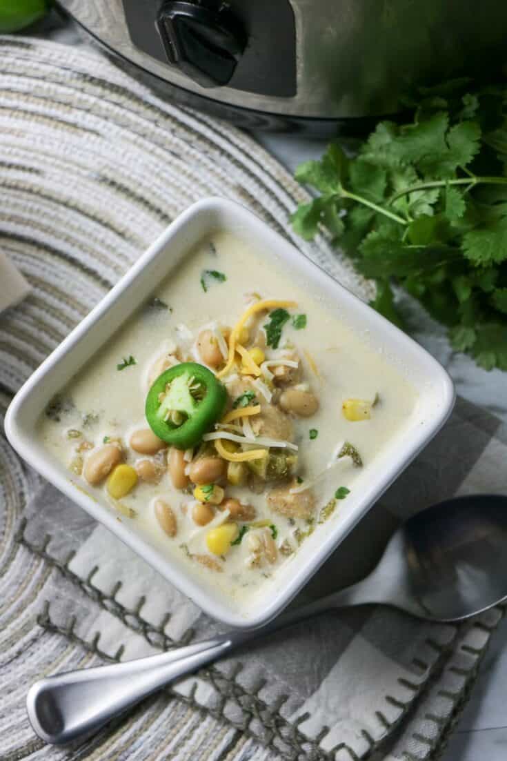 Slow Cooker White Bean and Chicken Enchilada Soup in white bowl