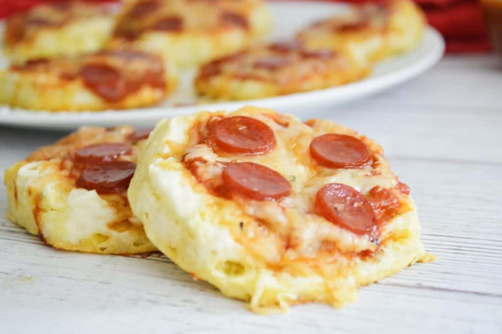 2 mini pepperoni pizzas foreground plate with mini pizzas background