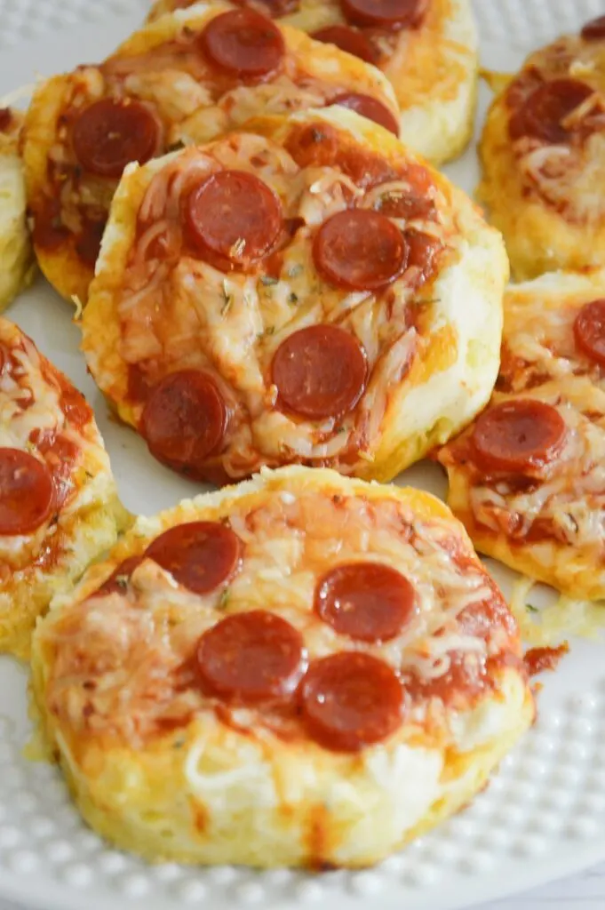 baked mini cheese pepperoni pizzas on white serving plate 