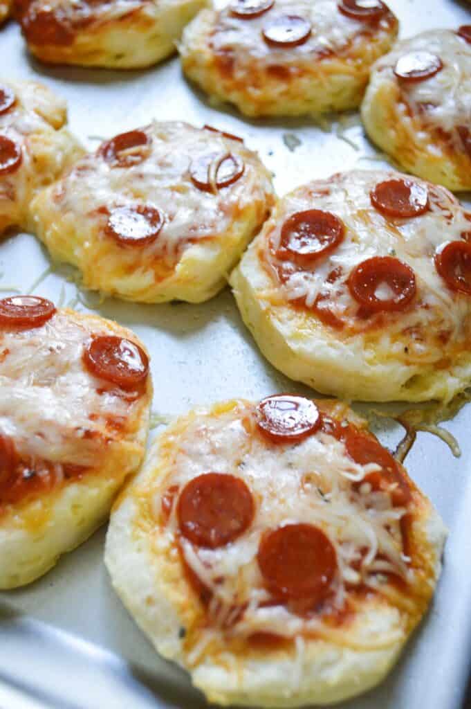 mini pepperoni pizzas on baking sheet