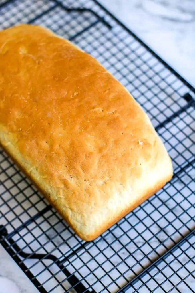 Top view of full loaf Bread in a bag vertical shot on a cooling rack