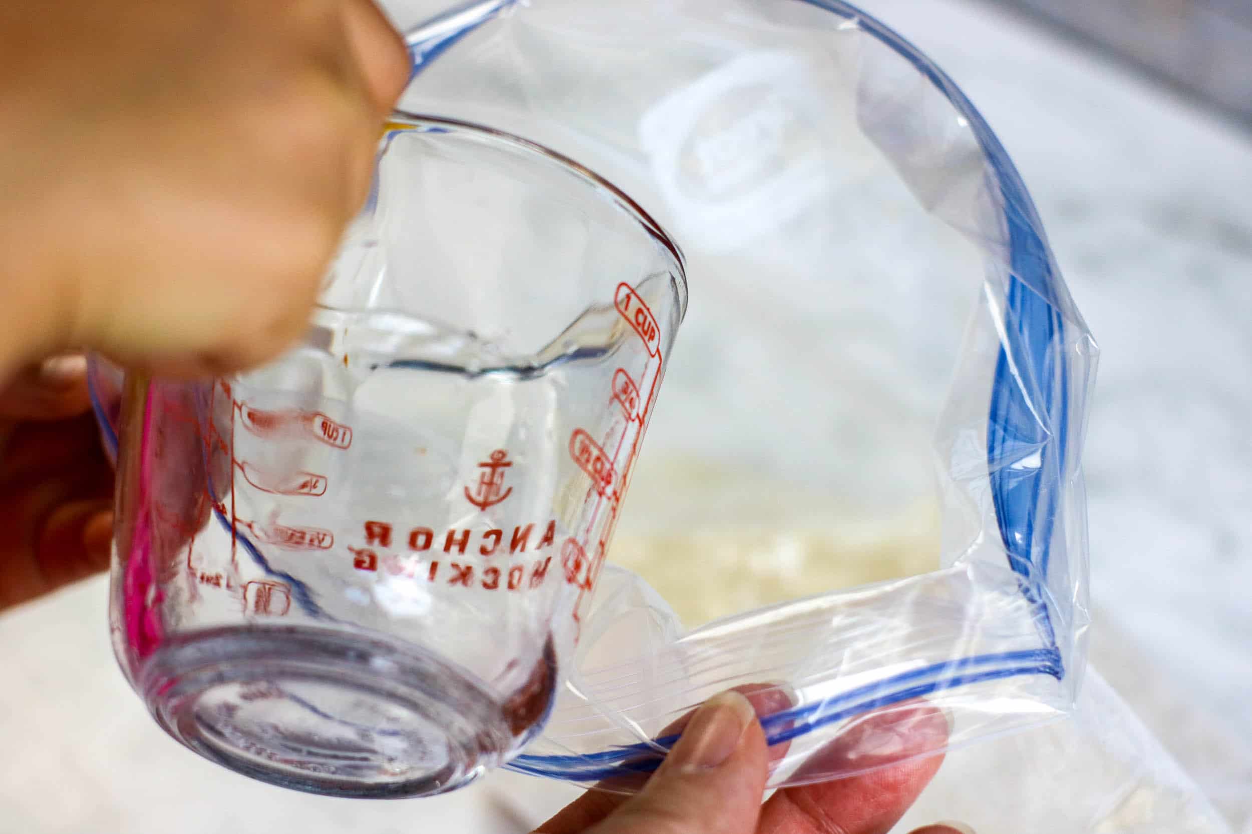Pouring water in a ziploc bag