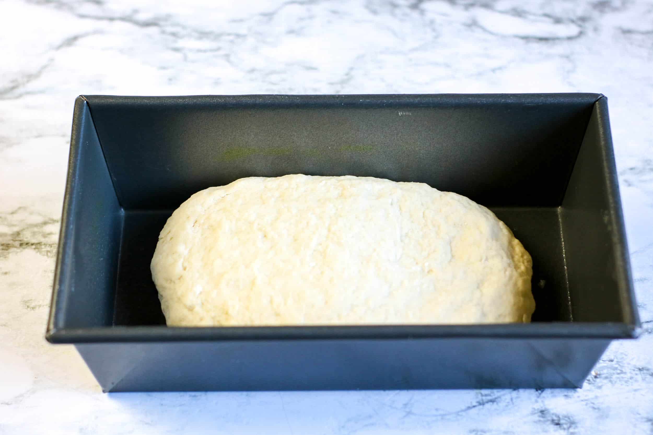 place dough for bread in a bag in a prepared loaf pan