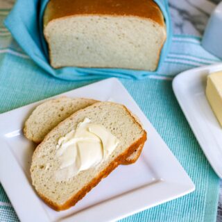 horizontal image bread in a bag recipe loaf of bread sliced bread with butter butter dish