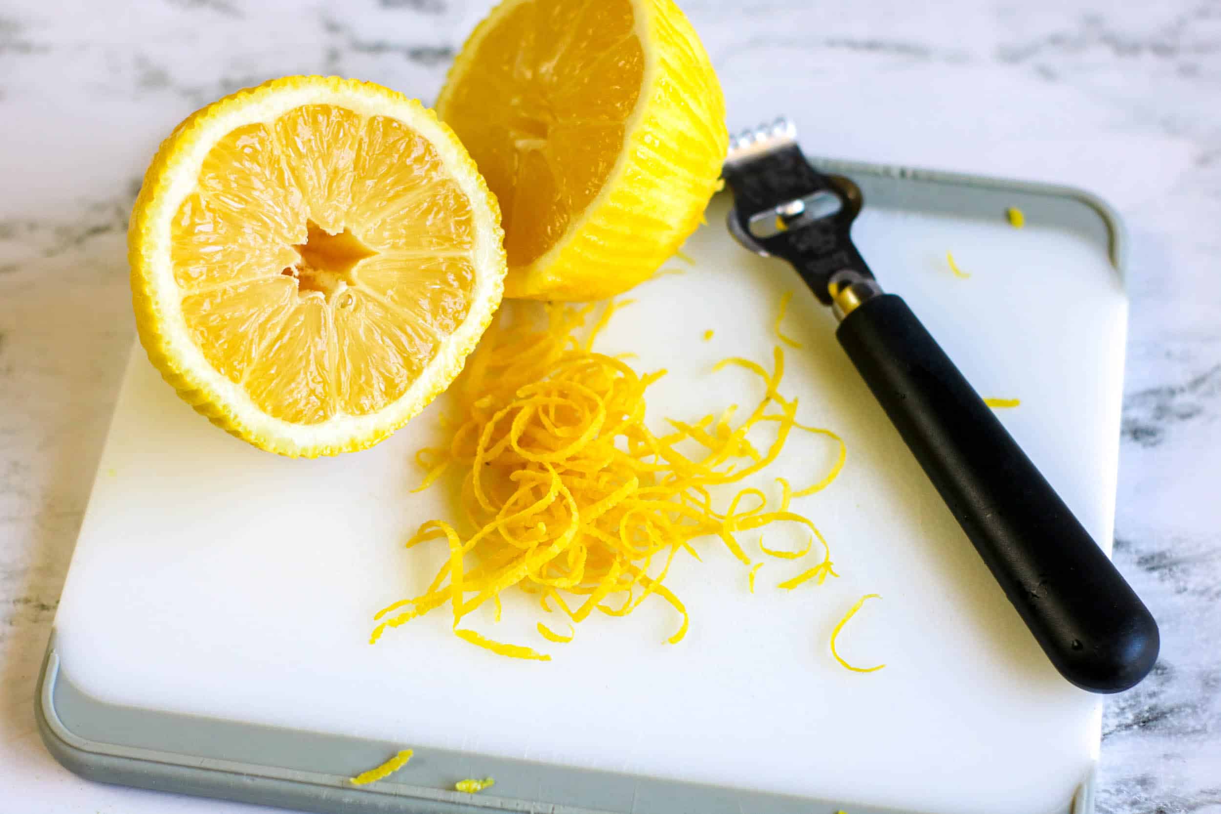 lemon is zested cut in half