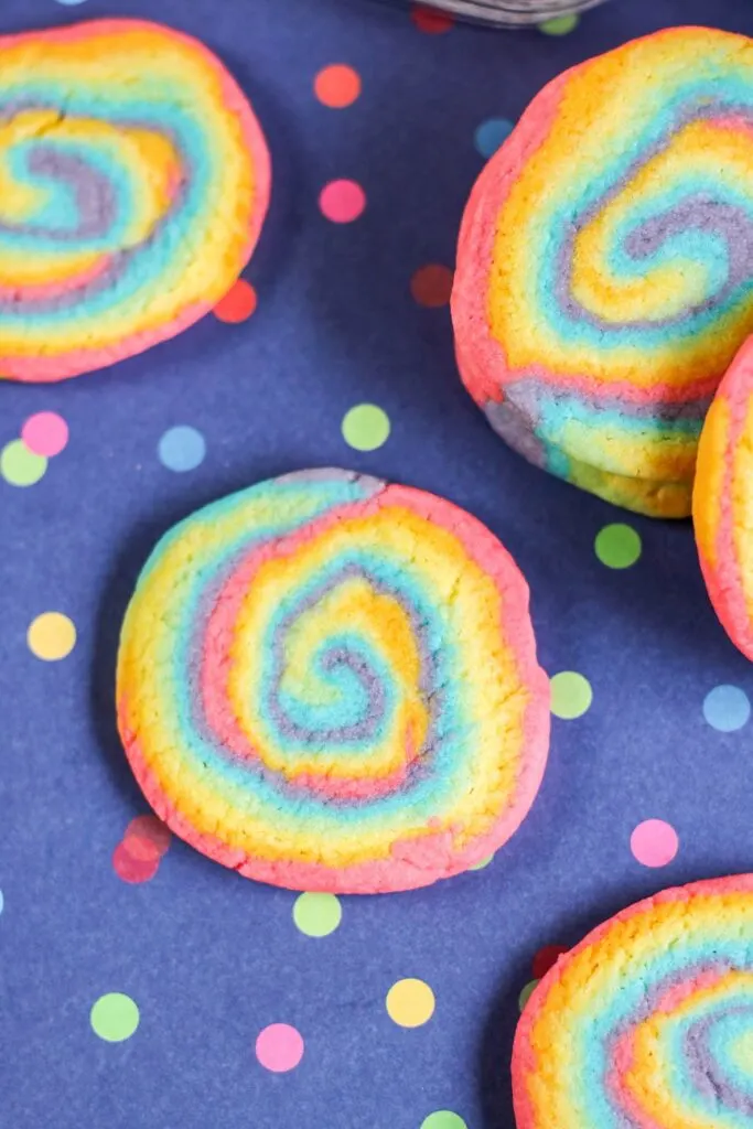 vertical shot rainbow swirl cookies blue tablecloth polka dots