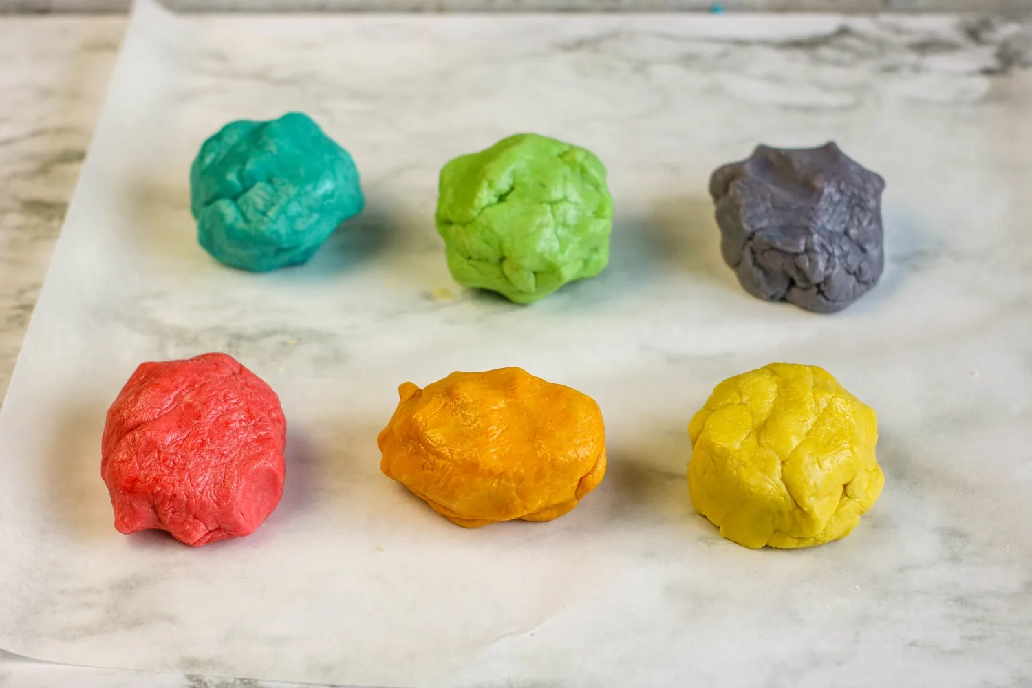 six different colors of cookie dough
